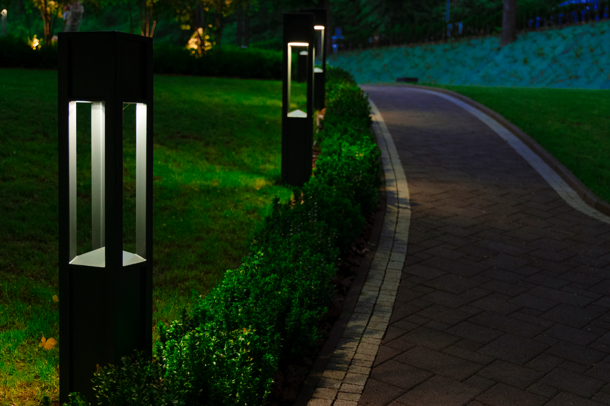 A decorative landscape lantern guides visitors along a garden footpath.