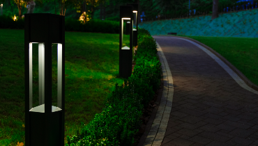 A decorative landscape lantern guides visitors along a garden footpath.