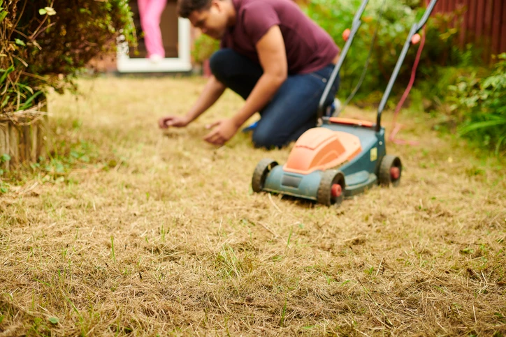 Man mowing a dead lawn | The Grounds Guys of Gettysburg