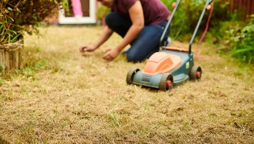 Man mowing a dead lawn | The Grounds Guys of Gettysburg