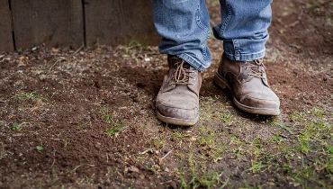 Person standing on a patchy lawn | The Grounds Guys of Gettysburg