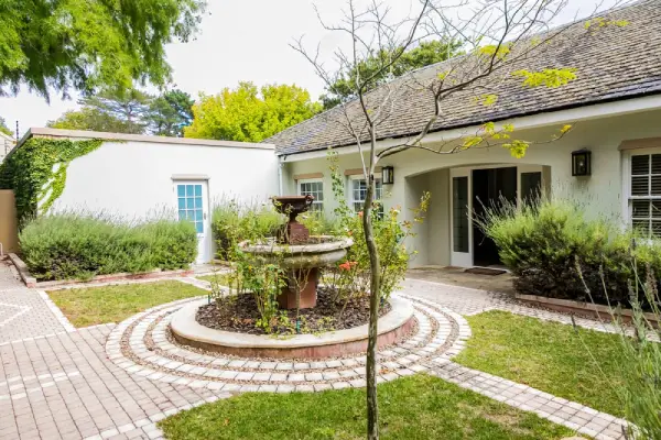 House with water feature in front yard.