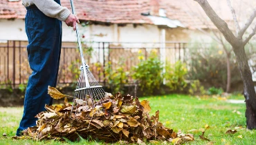 Man raking leaves - The Grounds Guys of Gettysburg