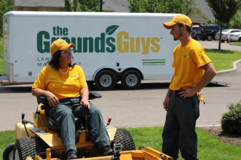 Landscapers mowing a lawn