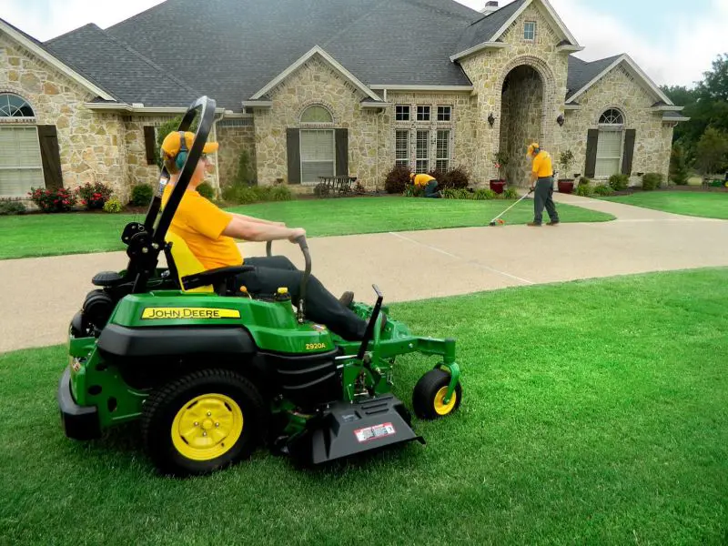 Grounds Guys doing lawn mowing and edging.