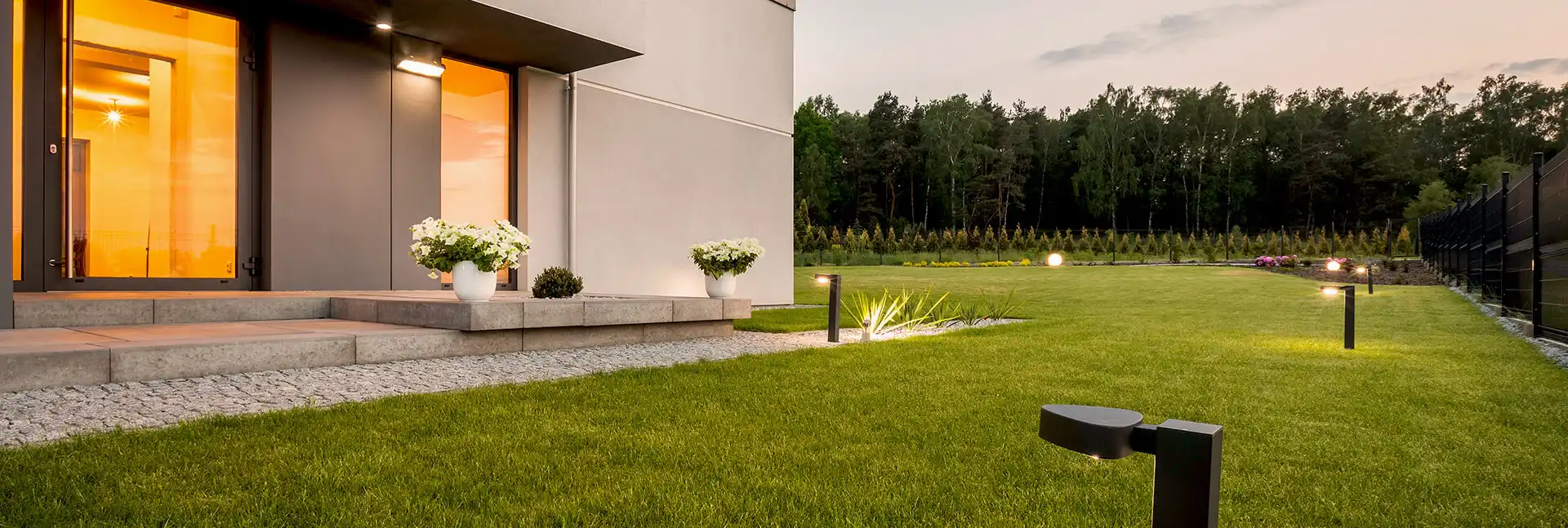 Back yard of a modern house with a well-manicured lawn