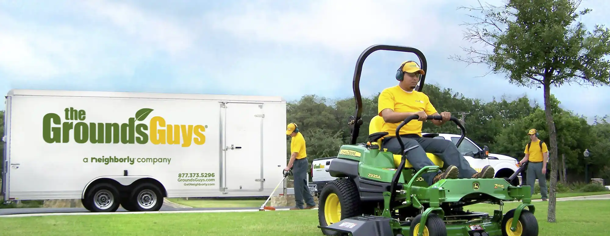 the grounds guys of beavercreek mowing a residential lawn