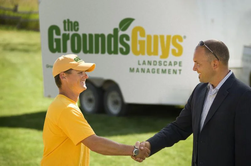 landscaper shaking hands with customer before tree trimming and removal