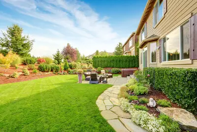 A gorgeous backyard with a flagstone landscape rock walkway